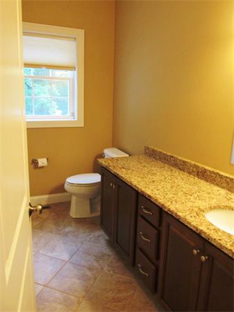 313 South Main Street Andover, MA 01810 - Photo 17 of 26 a bathroom with a granite countertop toilet and a sink