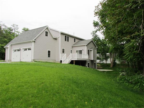 313 South Main Street Andover, MA 01810 - Photo 3 of 26 a view of a white house in front of a big yard with large trees