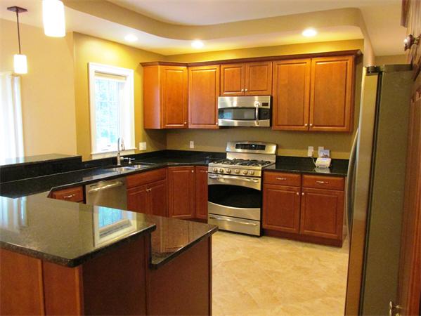 313 South Main Street Andover, MA 01810 - Photo 10 of 26 a kitchen with stainless steel appliances granite countertop a sink stove and refrigerator