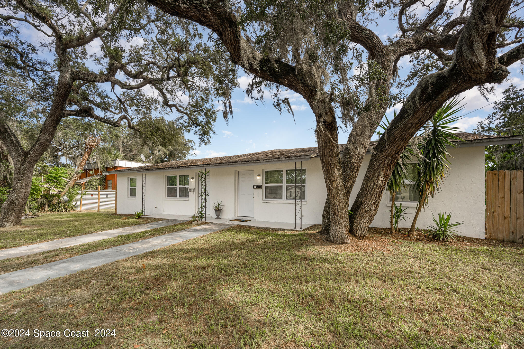 889-881 Sarno Road Melbourne, FL 32935 - Photo 1 of 25 a view of a house with a yard