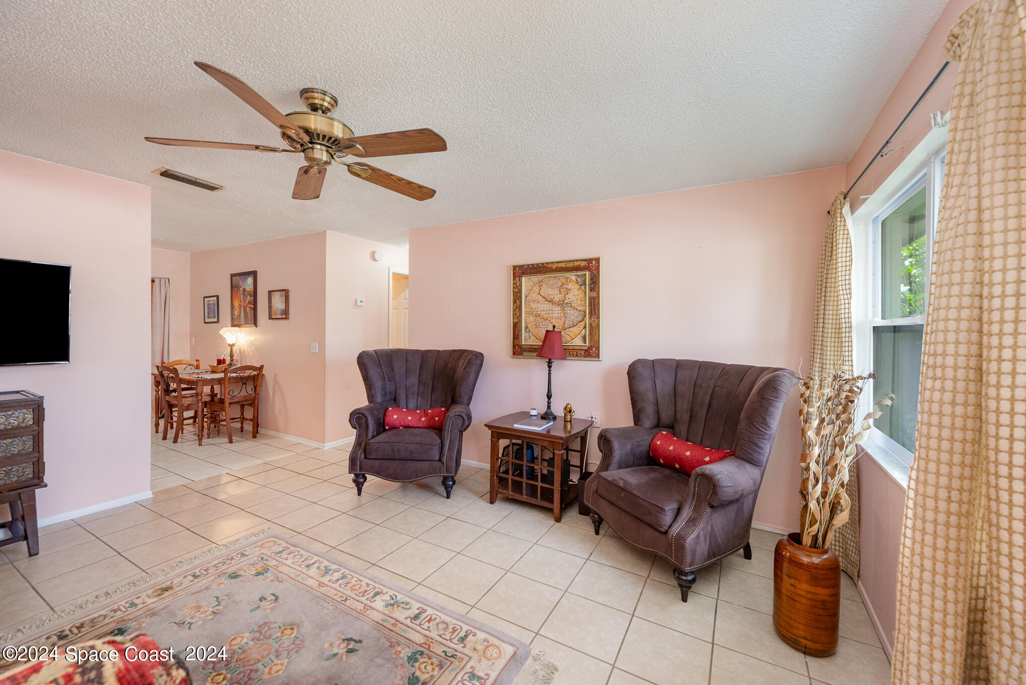 889-881 Sarno Road Melbourne, FL 32935 - Photo 12 of 25 a living room with furniture and a flat screen tv