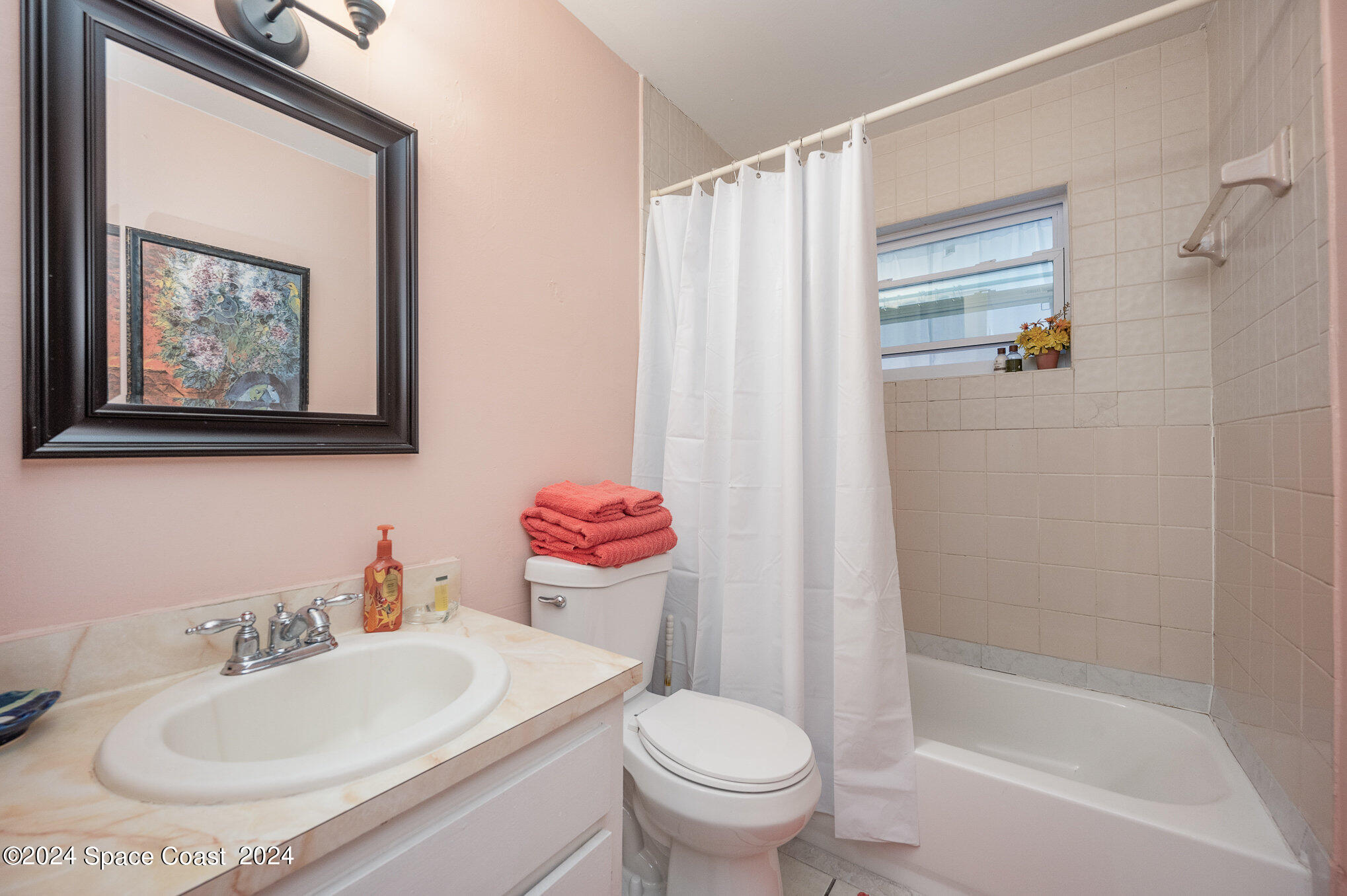 889-881 Sarno Road Melbourne, FL 32935 - Photo 18 of 25 a bathroom with a sink toilet and shower