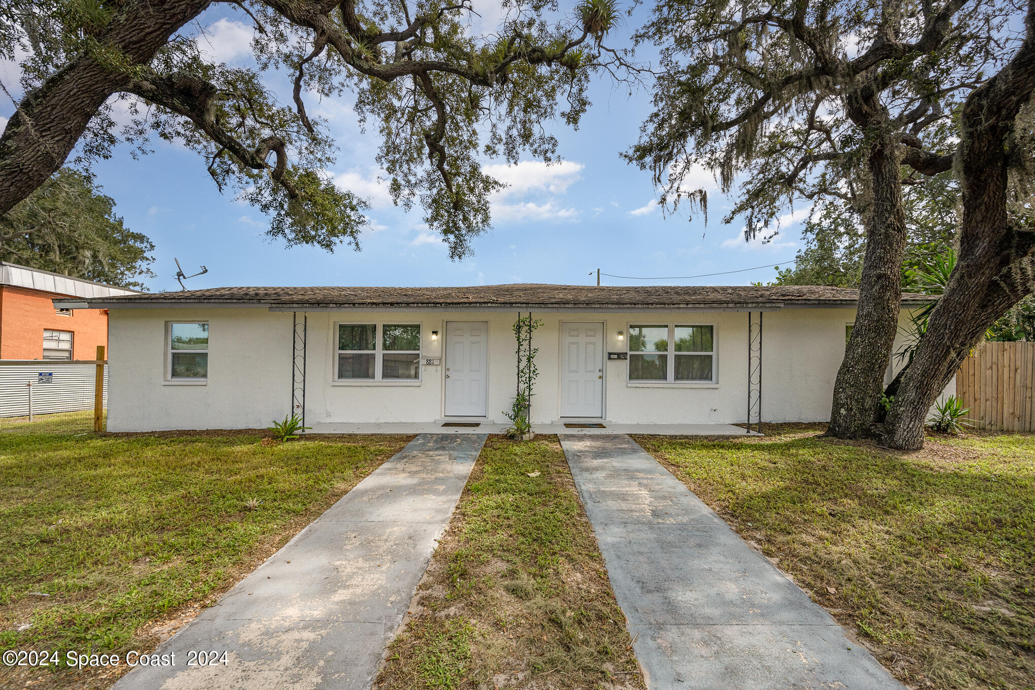 889-881 Sarno Road Melbourne, FL 32935 - Photo 2 of 25 front view of a house with a yard