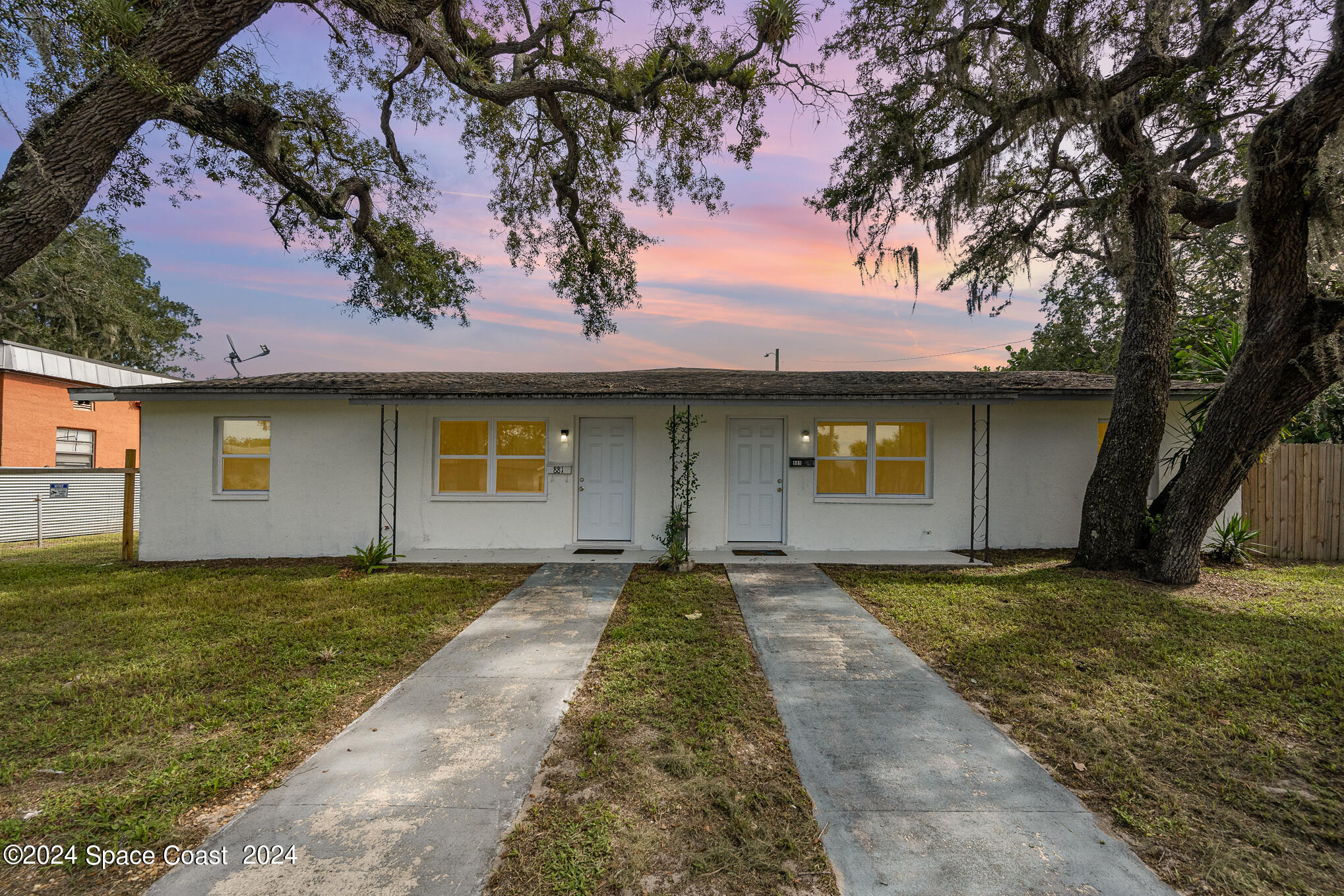 889-881 Sarno Road Melbourne, FL 32935 - Photo 23 of 25 a front view of a house with a yard