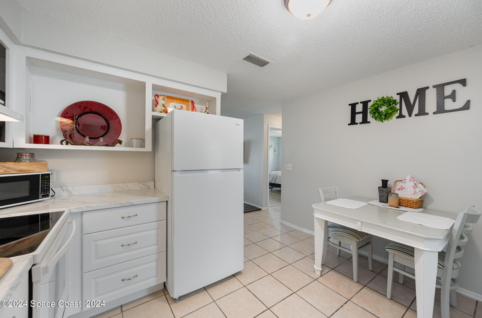 889-881 Sarno Road Melbourne, FL 32935 - Photo 3 of 25 a kitchen with appliances cabinets and furniture