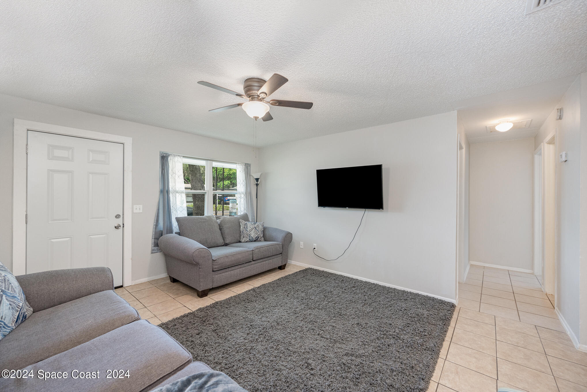889-881 Sarno Road Melbourne, FL 32935 - Photo 5 of 25 a living room with furniture and a flat screen tv