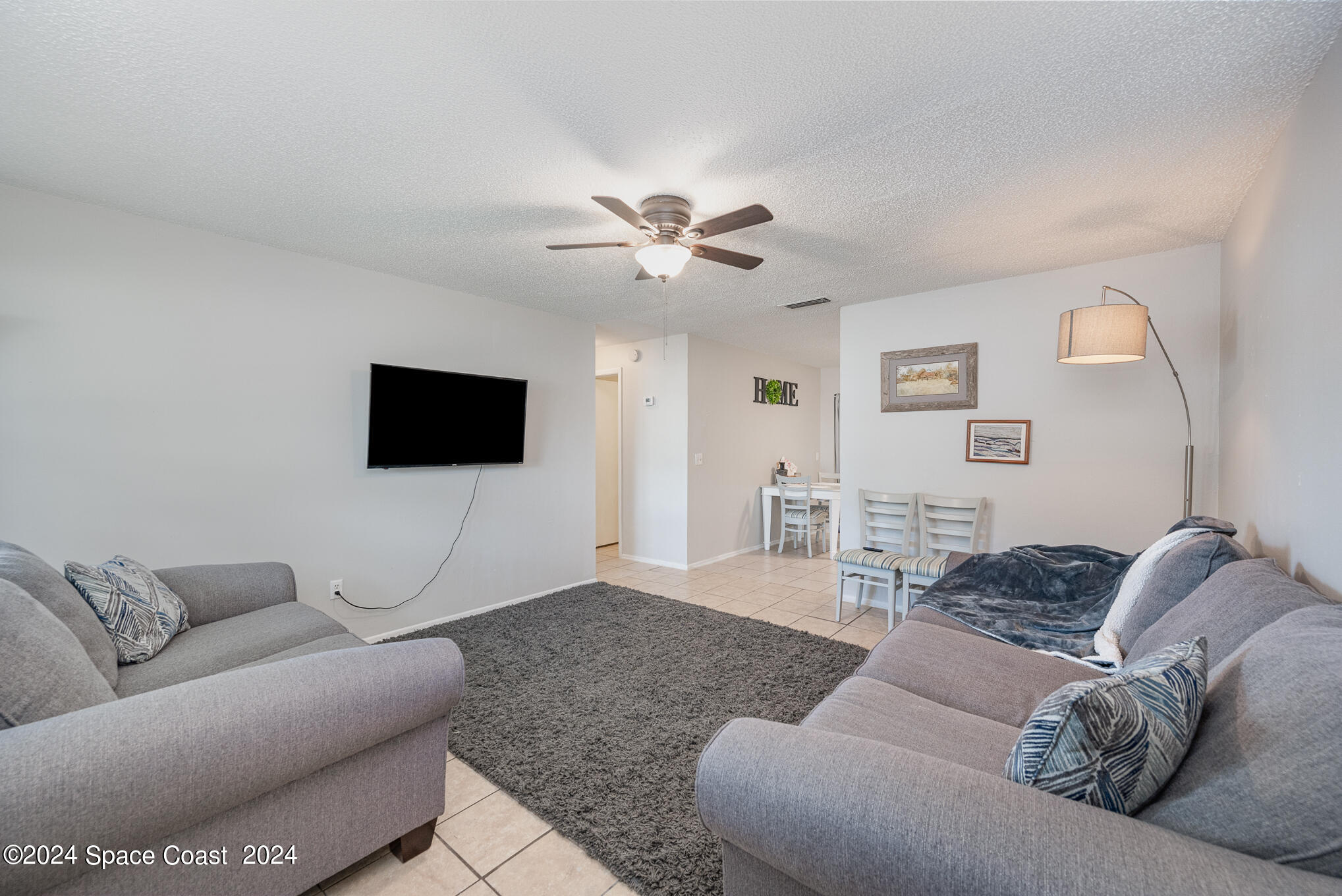 889-881 Sarno Road Melbourne, FL 32935 - Photo 6 of 25 a living room with furniture and a flat screen tv
