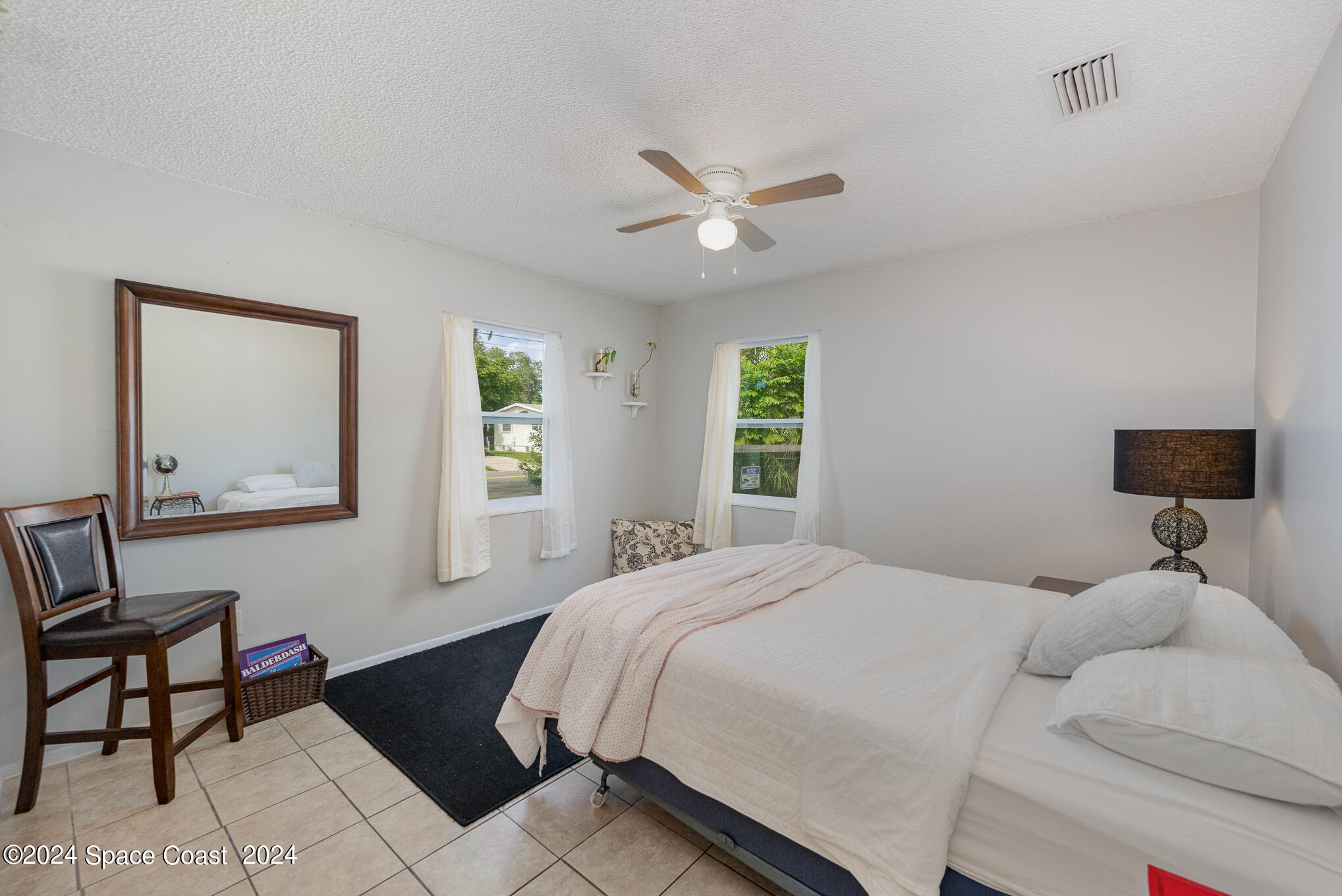 889-881 Sarno Road Melbourne, FL 32935 - Photo 7 of 25 a bedroom with a bed and a window