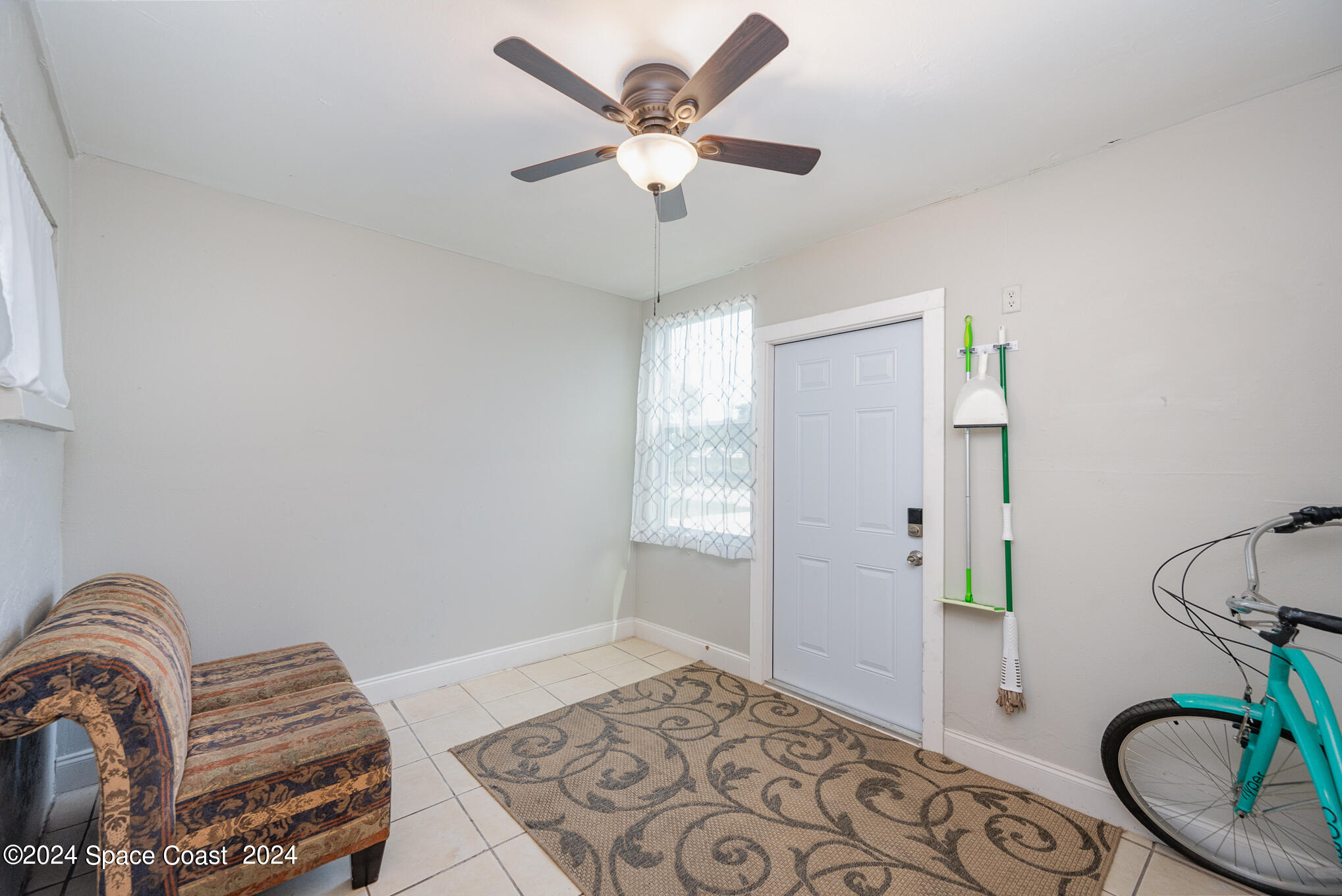 889-881 Sarno Road Melbourne, FL 32935 - Photo 10 of 25 a bedroom with bed and a chandelier