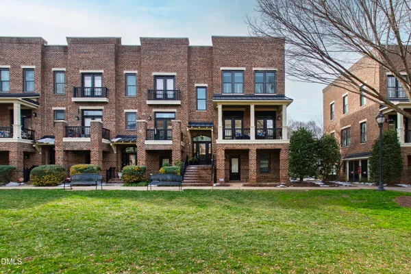a front view of building with yard and green space