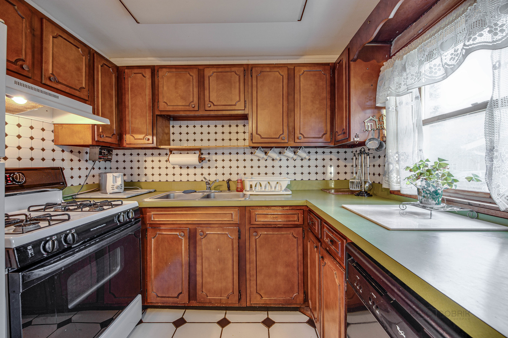 54 North Rohlwing Road Palatine, IL 60074 - Photo 12 of 24 a kitchen with stainless steel appliances a sink stove and cabinets