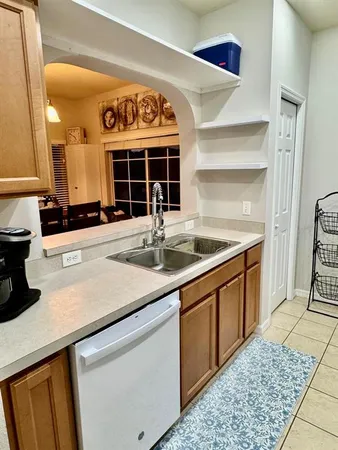 a kitchen with a sink and a stove top oven
