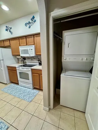 a kitchen with a stove top oven and cabinets