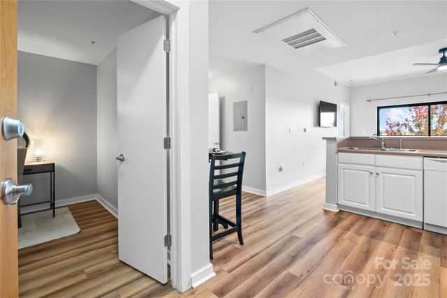 a hallway view with wooden floor and dining room