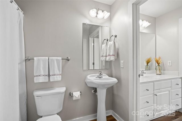 a bathroom with a sink toilet and mirror