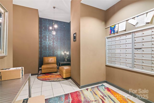 a view of an empty room and dining room