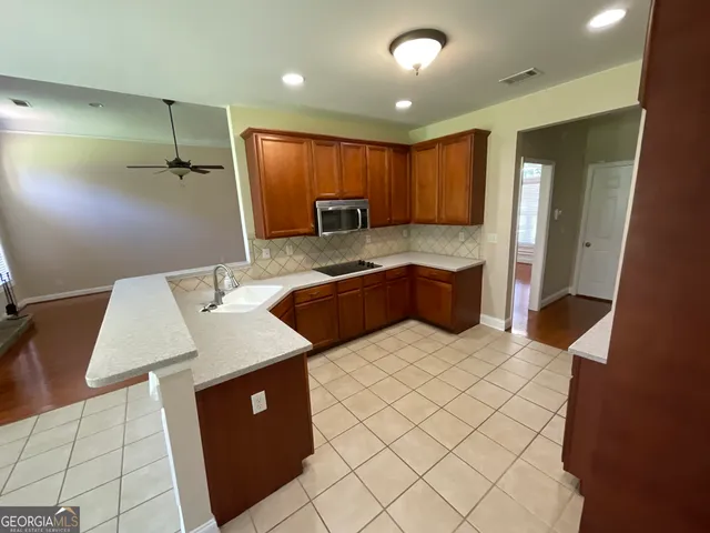 a kitchen with a sink and refrigerator