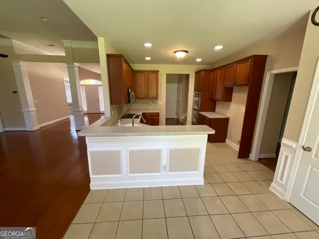 a view of a kitchen with a sink and a refrigerator