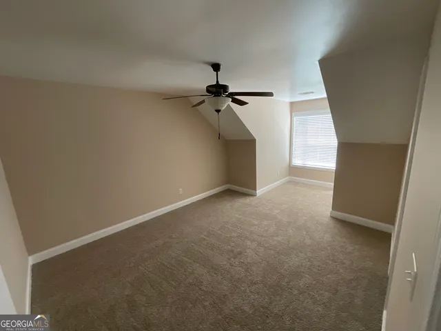 a view of a room with a ceiling fan