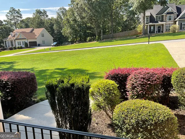 a view of balcony with a yard