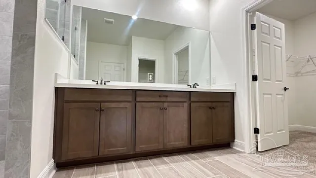 a bathroom with a double vanity sink and mirror