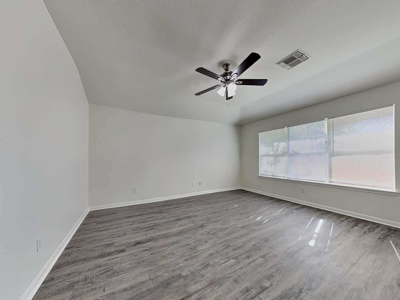 15407 Riford Drive Cypress, TX 77429 - Photo 12 of 13 an empty room with wooden floor and windows