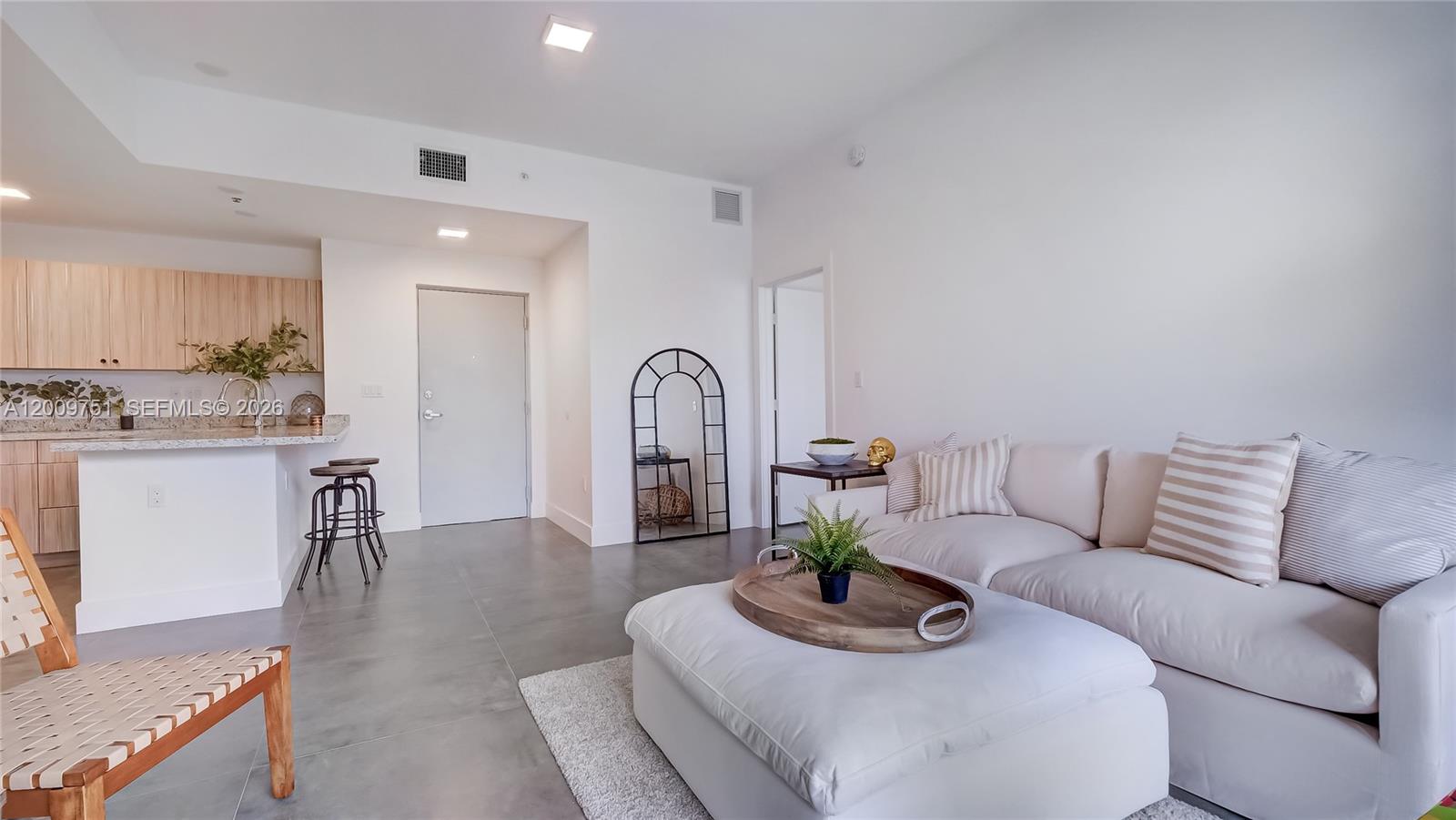 2010 Southwest 25th Terrace, Unit 404 Miami, FL 33133 - Photo 11 of 17 a living room with furniture and wooden floor