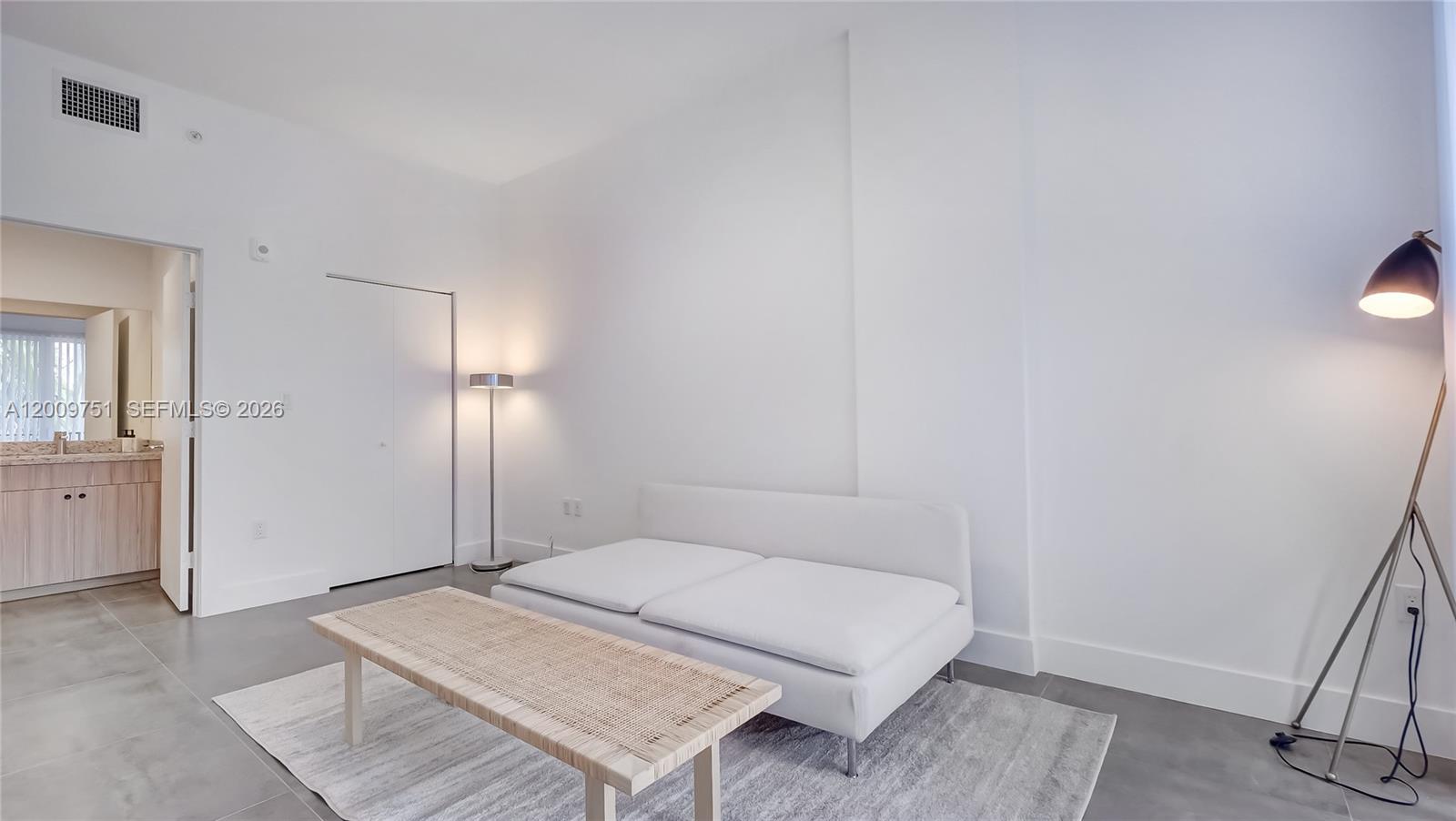 2010 Southwest 25th Terrace, Unit 404 Miami, FL 33133 - Photo 15 of 17 a spacious bedroom with a bed and a table