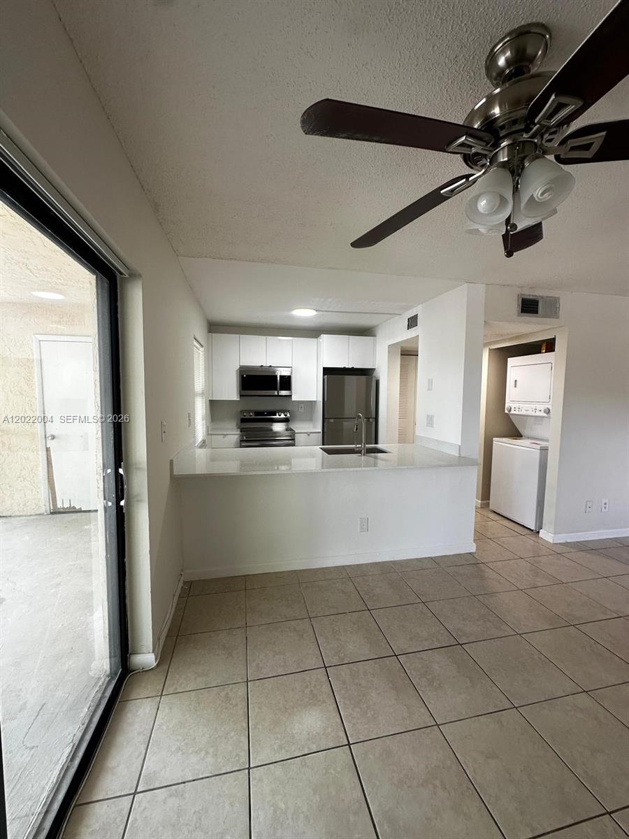 3400 Foxcroft Road, Unit 301 Miramar, FL 33025 - Photo 17 of 72 a large white kitchen with a stove a refrigerator and a sink