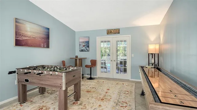 a living room with furniture kitchen view and a chandelier