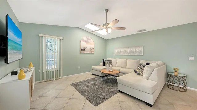 a kitchen with stainless steel appliances lots of counter top space and furniture