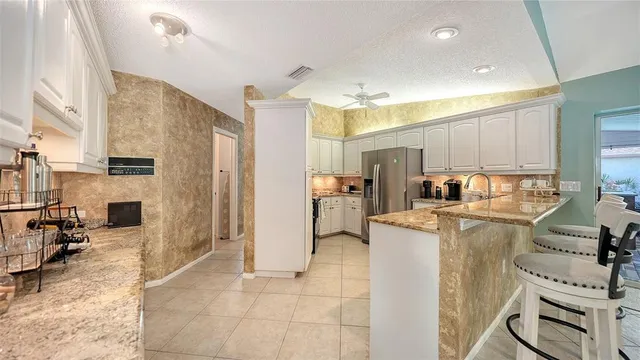 a bathroom with a granite countertop sink a mirror and a bathtub