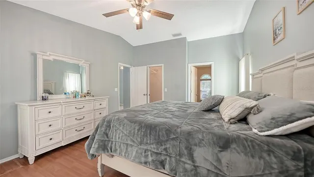 a bedroom with a large bed and a chandelier