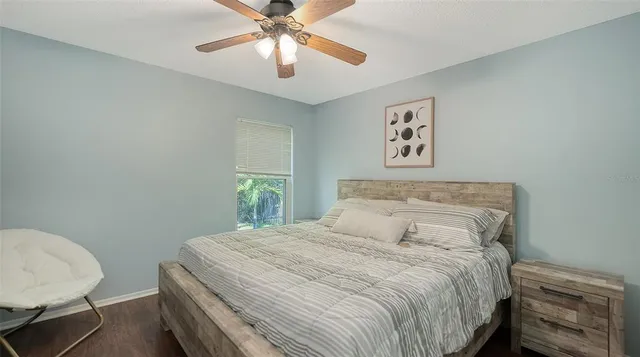a bedroom with a bed and a ceiling fan