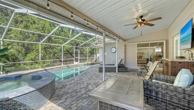 a view of a house with backyard porch and sitting area