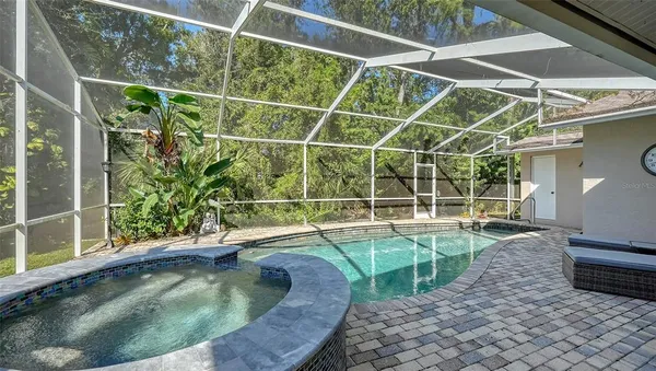 a view of a patio with a table chairs and a backyard