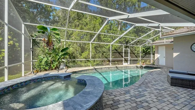 a view of a patio with a table chairs and a backyard