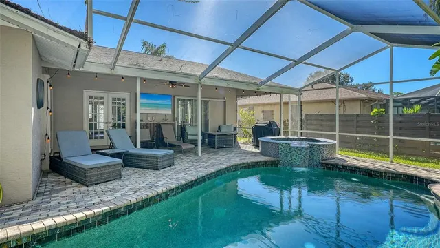 a view of a deck with chairs and wooden fence