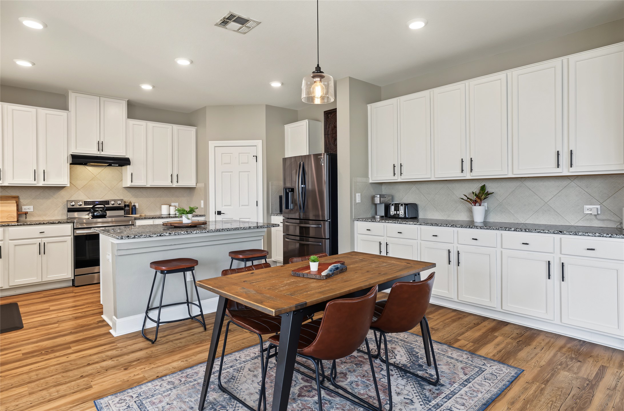 7501 Janes Ranch Road Austin, TX 78744 - Photo 6 of 19 The kitchen & casual dine-in space comes with outstanding counter & cupboard storage space.