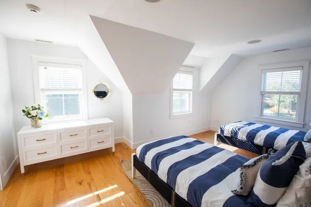 a bedroom with two beds and a window