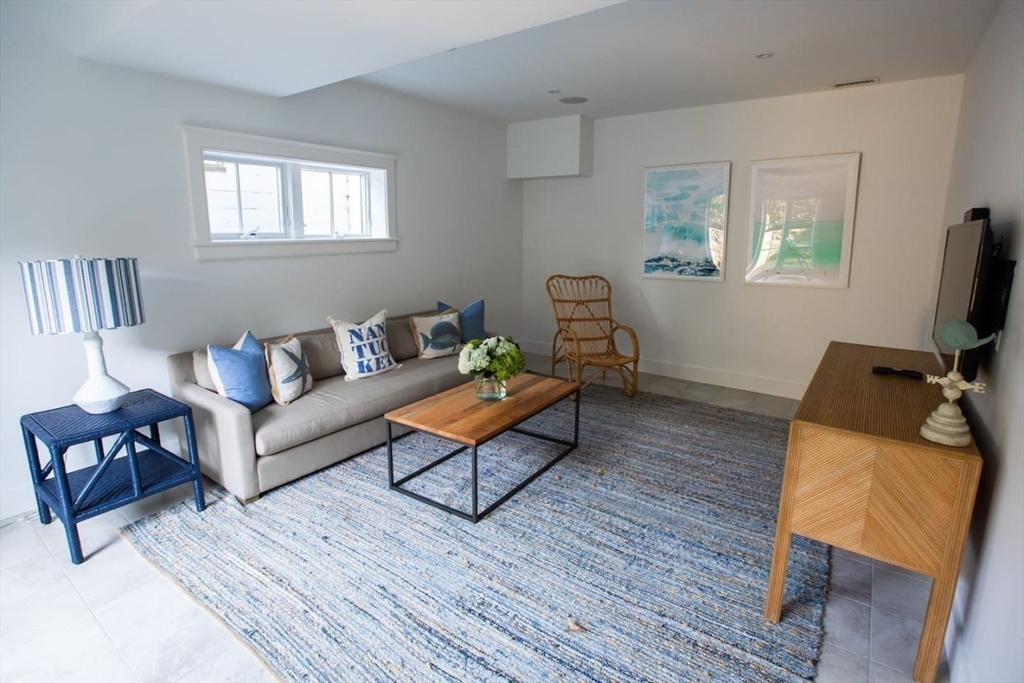 43 Vestal Street Nantucket, MA 02554 - Photo 16 of 19 a living room with furniture and a flat screen tv
