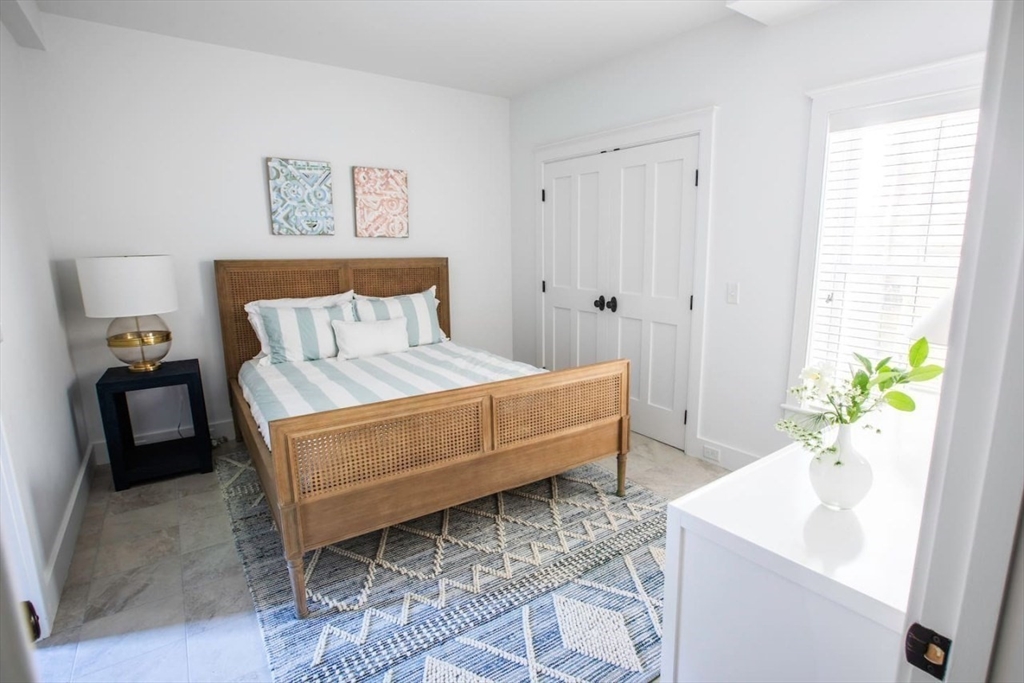 43 Vestal Street Nantucket, MA 02554 - Photo 18 of 19 a bedroom with a bed and a table in it