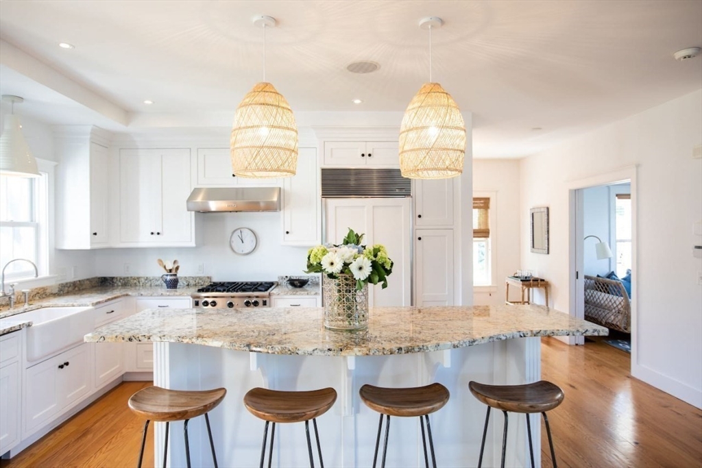 43 Vestal Street Nantucket, MA 02554 - Photo 5 of 19 a kitchen with stainless steel appliances granite countertop a table and chairs in it