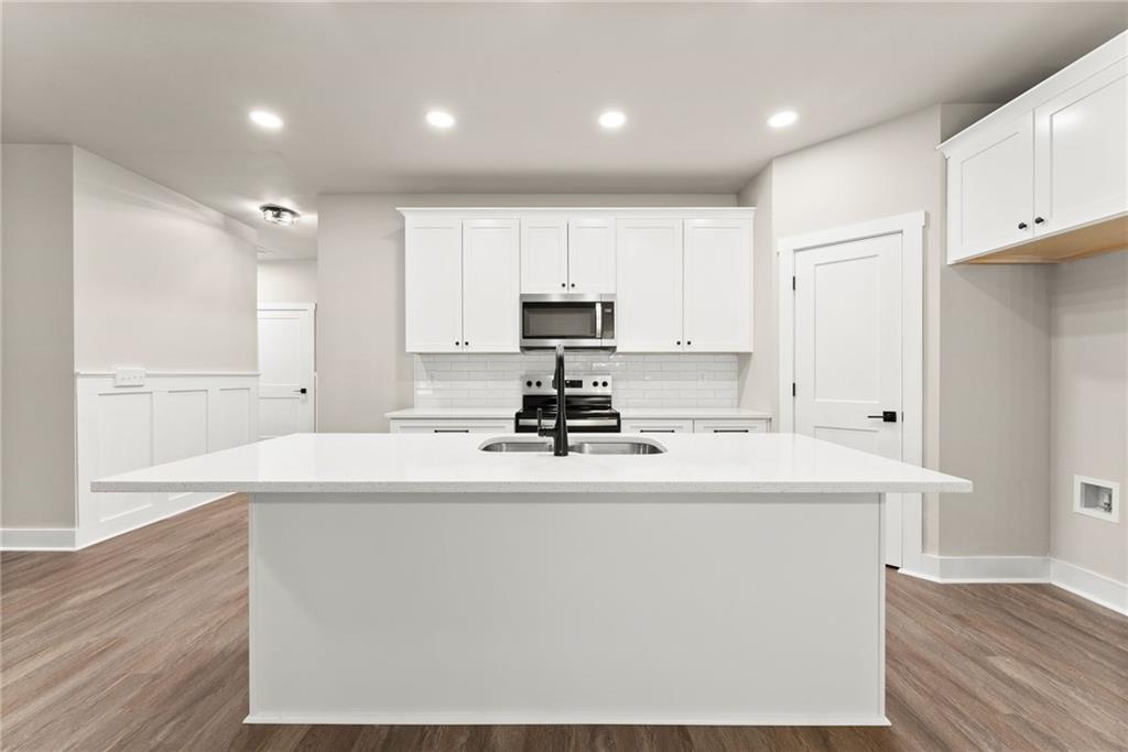 43 Anderson Street Jefferson, GA 30549 - Photo 8 of 45 a kitchen with kitchen island sink stove and refrigerator