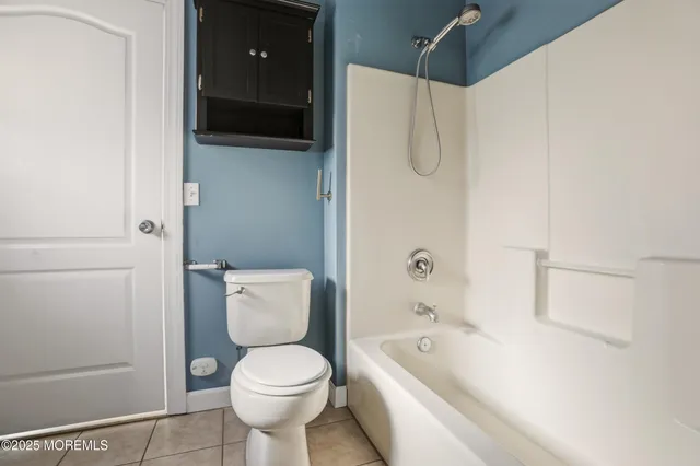 a bathroom with a toilet a sink and bathtub