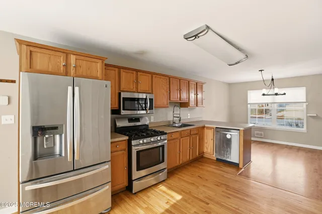 a kitchen with stainless steel appliances a refrigerator stove and sink