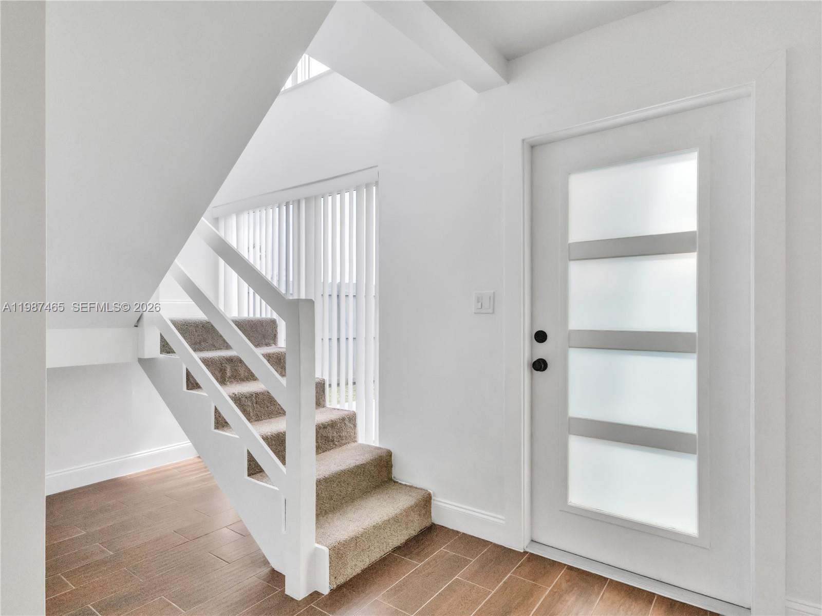 6505 Southwest 113th Place Miami, FL 33173 - Photo 11 of 25 a view of staircase with white walls and windows