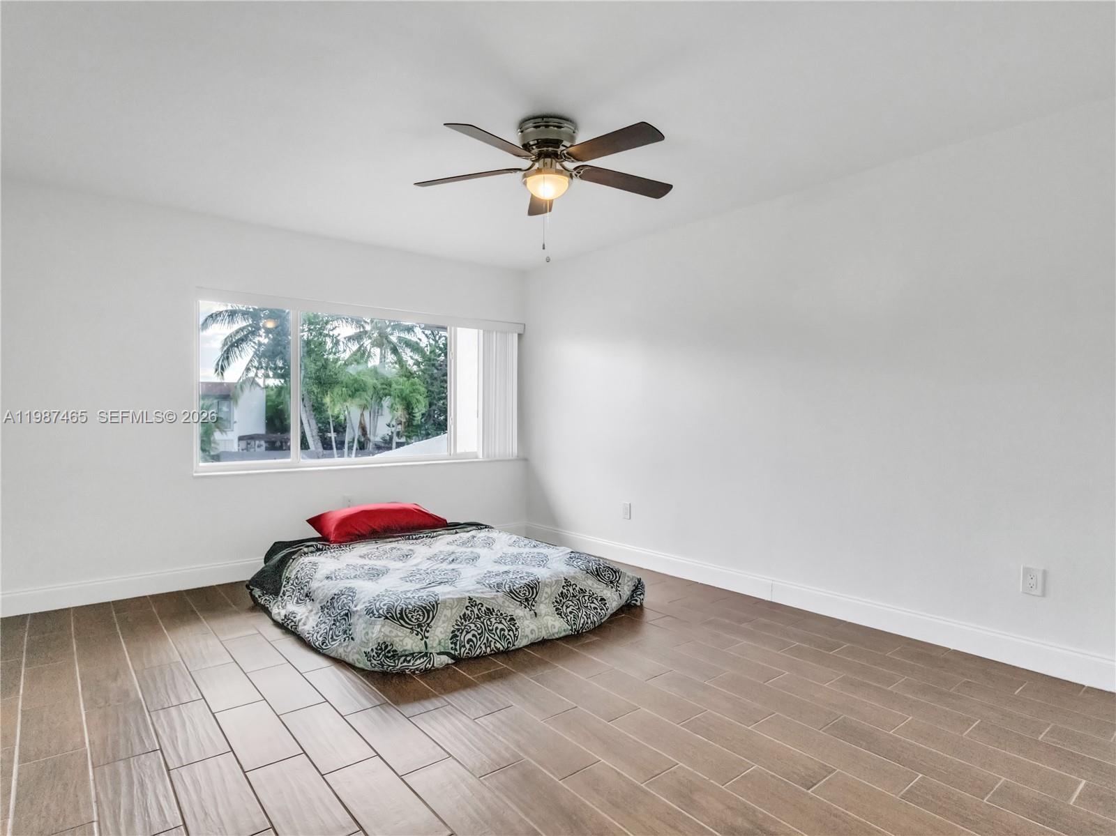 6505 Southwest 113th Place Miami, FL 33173 - Photo 14 of 25 a view of a room with wooden floor and window