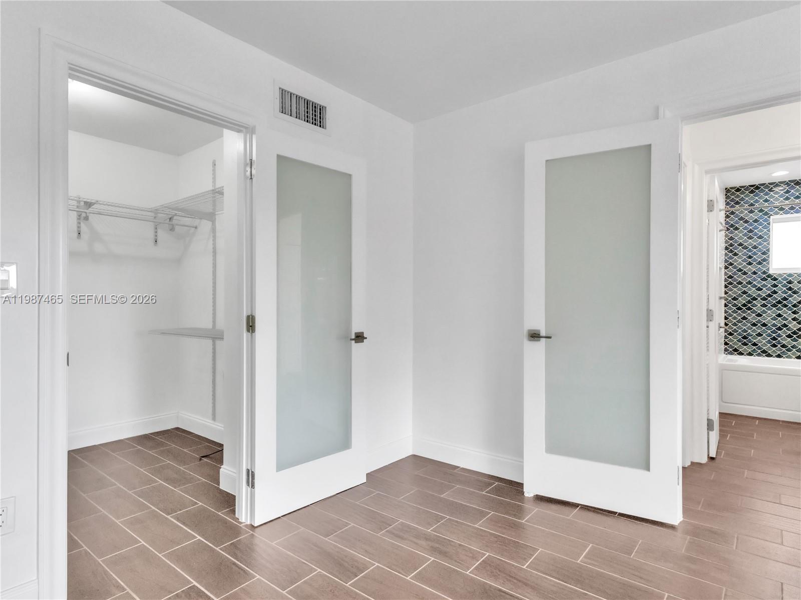 6505 Southwest 113th Place Miami, FL 33173 - Photo 16 of 25 a view of a bathroom with a glass door shower