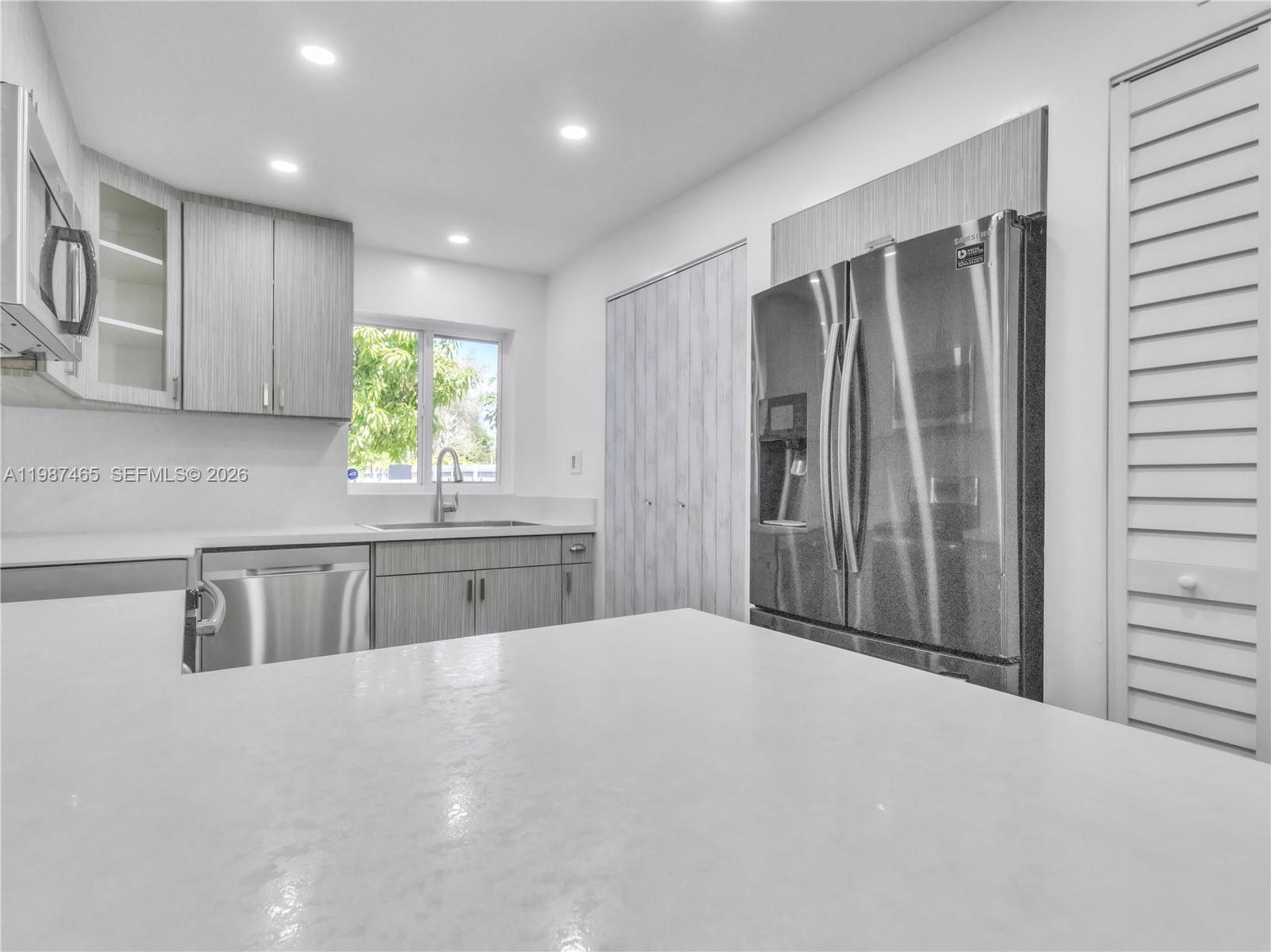 6505 Southwest 113th Place Miami, FL 33173 - Photo 4 of 25 a kitchen with stainless steel appliances granite countertop a refrigerator and a sink